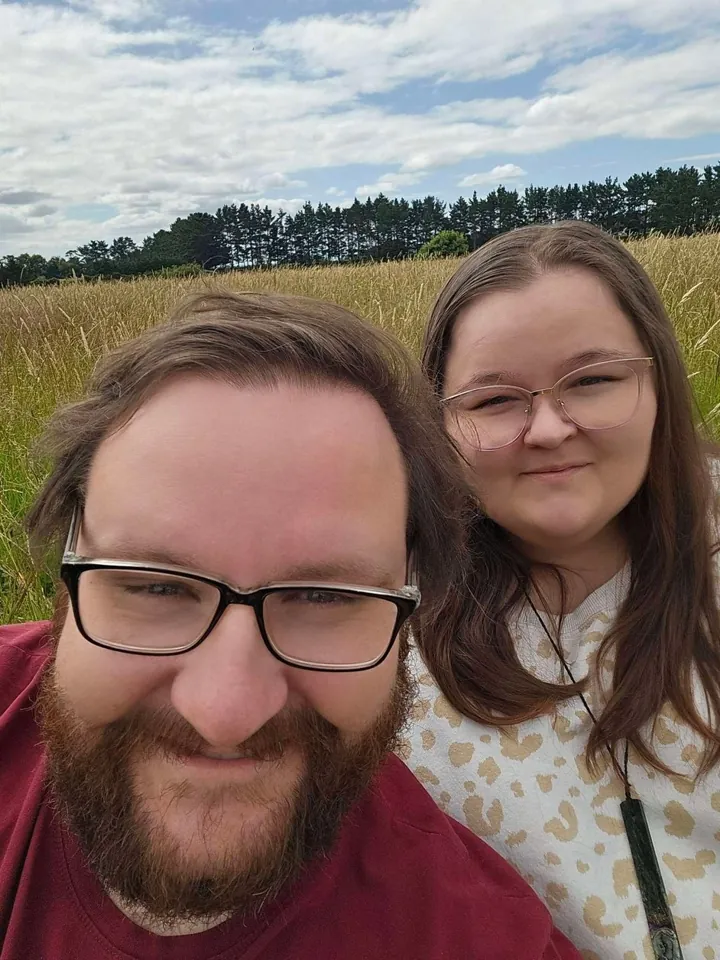 Joel and Ashlee Mackereth, the founders of Baseline Mapping, in a paddock of long grass